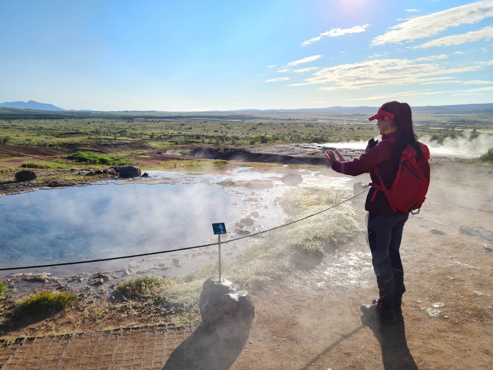 Hände wärmen an der Konungshver - im Geothermalfeld Haukadalur - Golden Circle (Island)